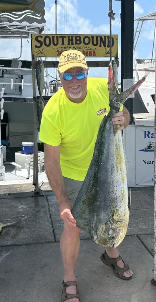 Customer with 22 lb Bull Dolphin at the dock